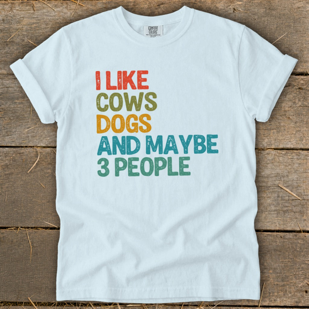 White t-shirt with text "I LIKE COWS DOGS AND MAYBE 3 PEOPLE".