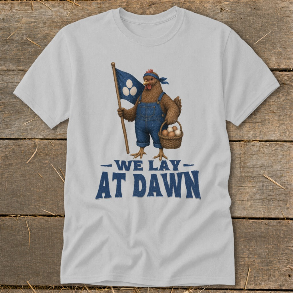 Chicken in overalls holding flag and basket of eggs, text reads "WE LAY AT DAWN".