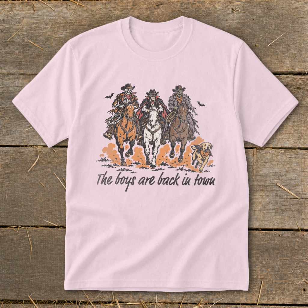 T-shirt with illustration of three skeleton cowboys on horses and a dog, text "The boys are back in town".