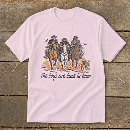 T-shirt with illustration of three skeleton cowboys on horses and a dog, text "The boys are back in town".