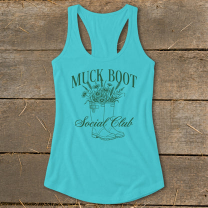 Turquoise tank top with "Muck Boot Social Club" text and floral boots graphic.