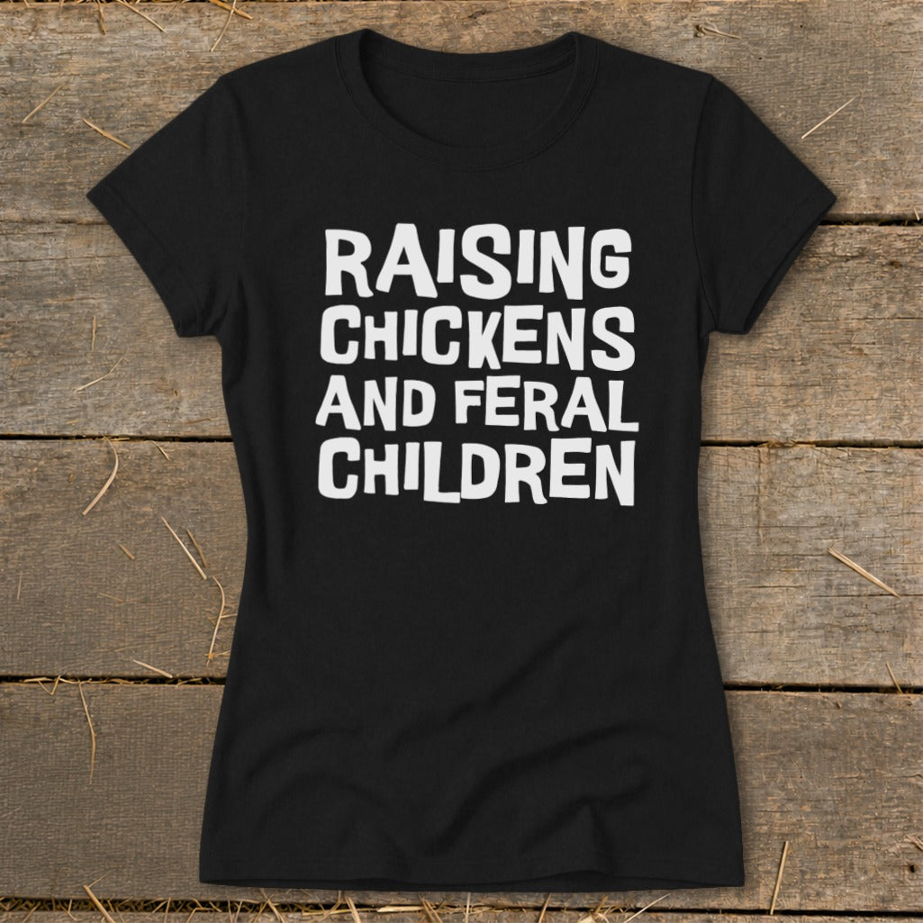 Black t-shirt with white text "RAISING CHICKENS AND FERAL CHILDREN".