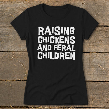 Black t-shirt with white text "RAISING CHICKENS AND FERAL CHILDREN".