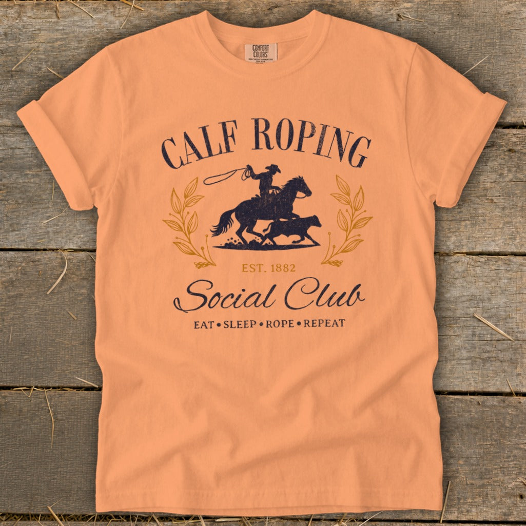 Peach t-shirt with Calf Roping Social Club graphic, including horse, rider, and calf.