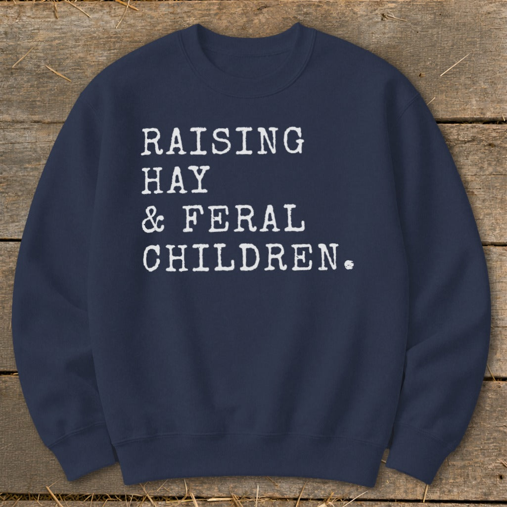 Navy sweatshirt with white text "RAISING HAY & FERAL CHILDREN."