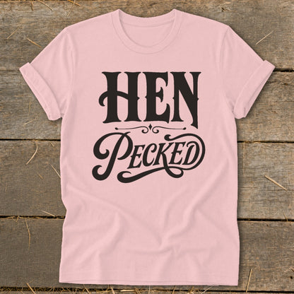 Light pink t-shirt with black text reading "HEN PECKED" in stylized lettering.