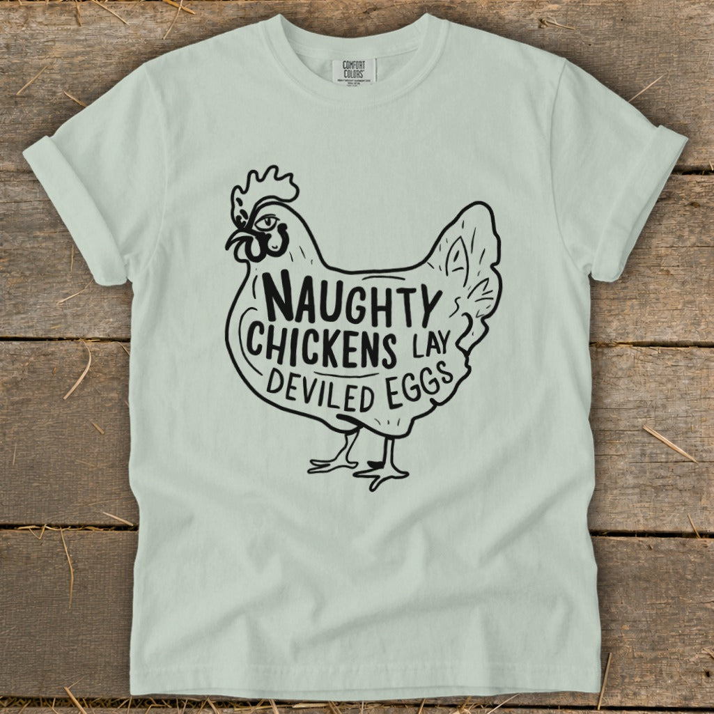 Light mint green t-shirt with black graphic of a chicken saying "Naughty Chickens Lay Deviled Eggs".