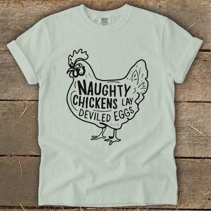 Light mint green t-shirt with black graphic of a chicken saying "Naughty Chickens Lay Deviled Eggs".