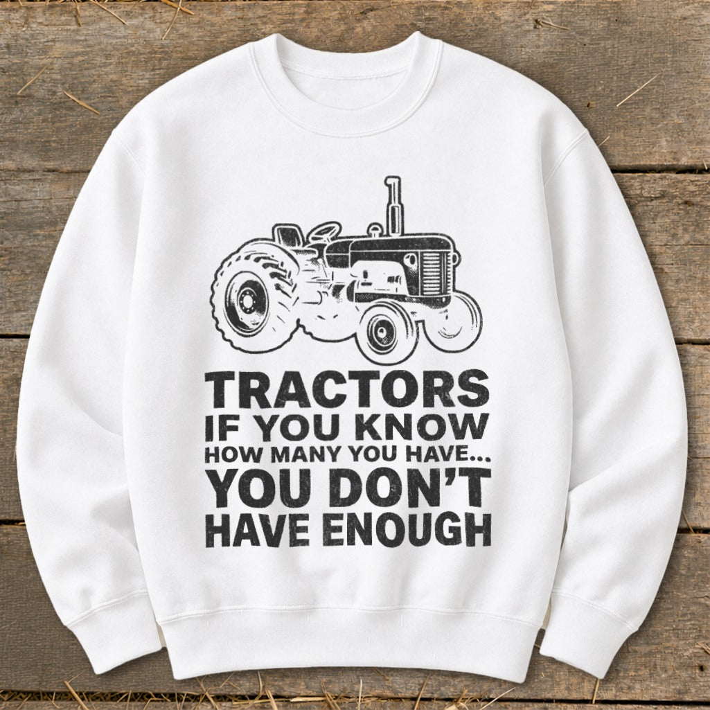 White sweatshirt with tractor graphic and text "Tractors If You Know How Many You Have... You Don't Have Enough".