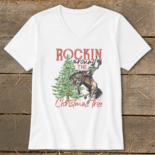 White t-shirt graphic with "Rockin' Around The Christmas Tree" and a rodeo rider on a bucking horse.
