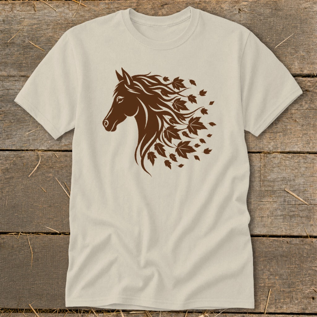 Brown horse head with flowing mane transitioning into autumn leaves on a tan t-shirt.
