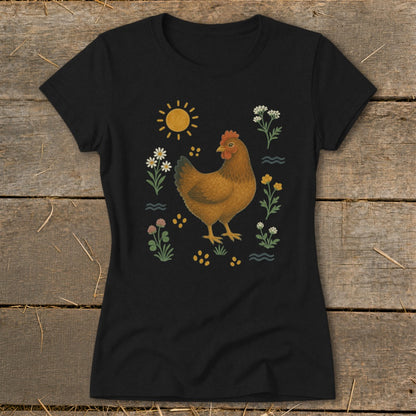 Black t-shirt with a brown hen surrounded by flowers, clover, and a sun.