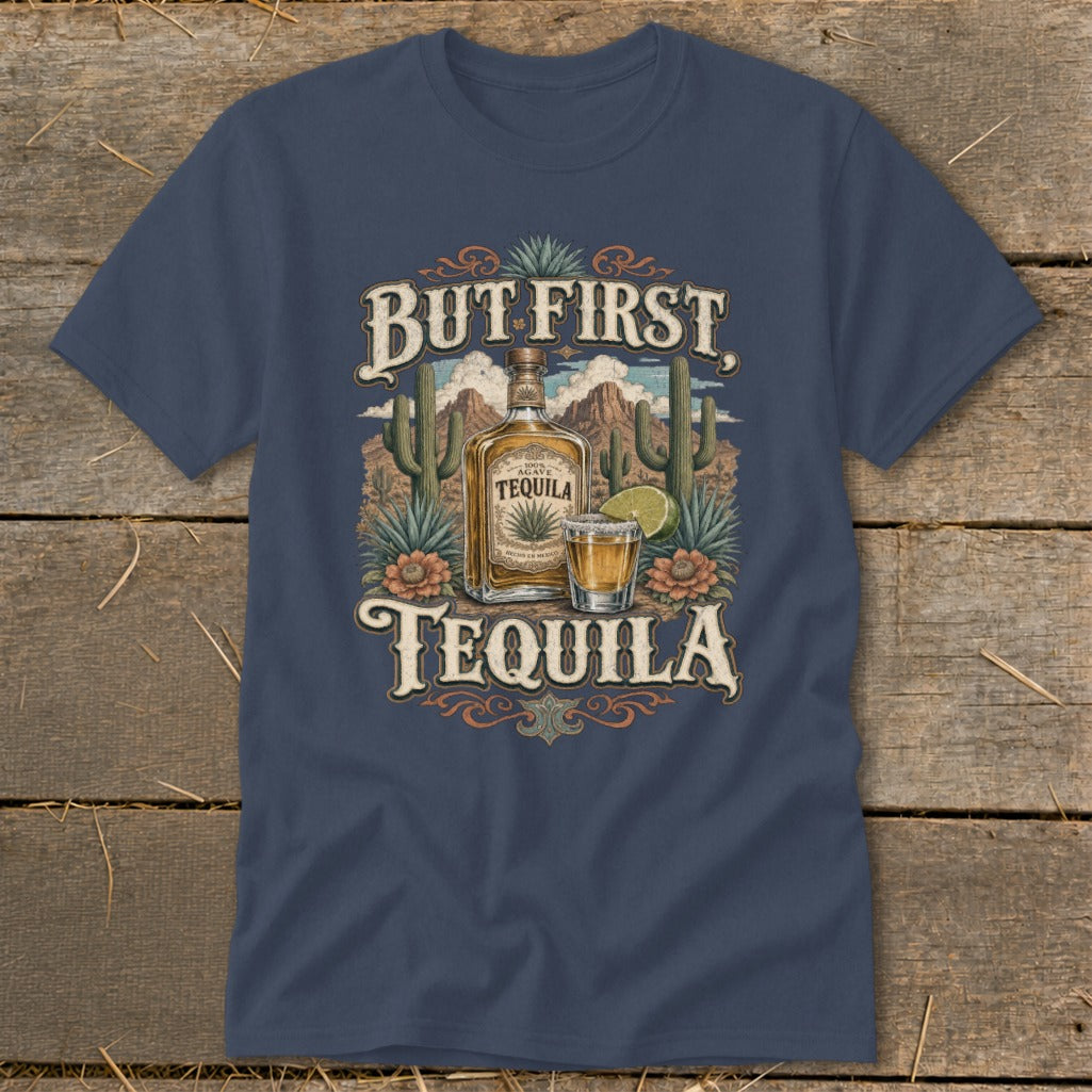T-shirt graphic with "But First Tequila" text, agave bottle, shot glass, and desert landscape.