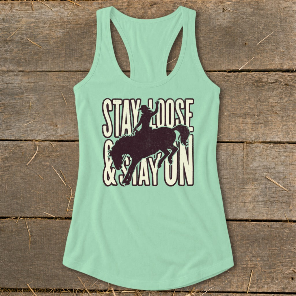 Mint green tank top with distressed "Stay Loose & Stay On" text and bucking bronco graphic.