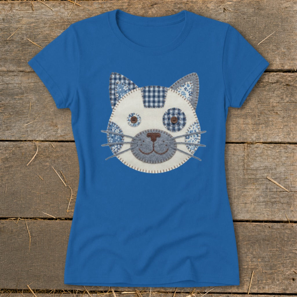 Blue t-shirt with a fabric applique of a cat's face.