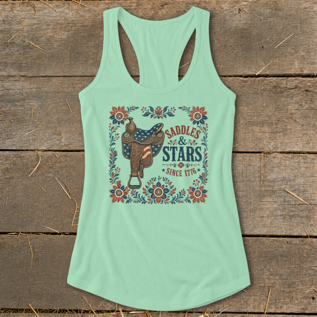 Light green tank top with "Saddles & Stars Since 1776" graphic featuring an American flag saddle.