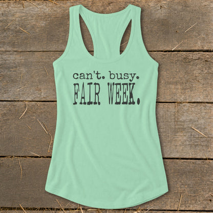 Mint green racerback tank top with black text that reads "can't. busy. FAIR WEEK."