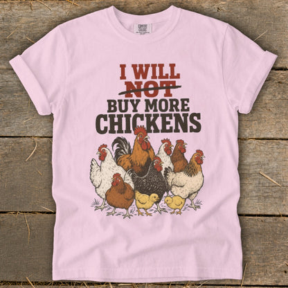 Pink t-shirt with text "I will not buy more chickens" and illustrations of chickens.