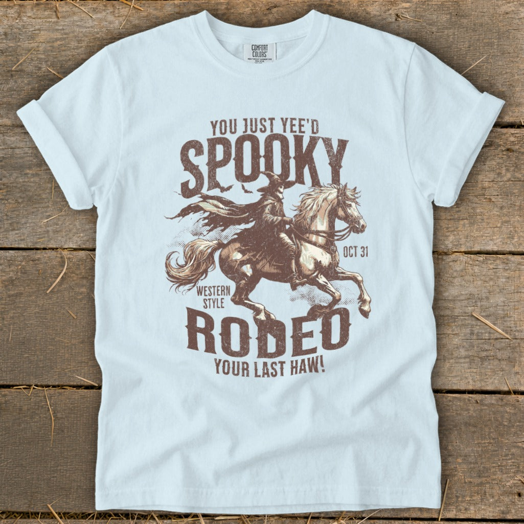 Light blue t-shirt with spooky cowboy on horse graphic and text "Spooky Rodeo Your Last Haw!"