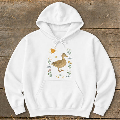 White hoodie with a watercolor illustration of a mallard duck and wildflowers.