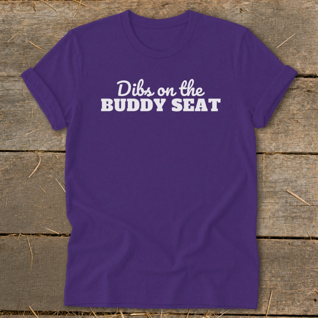 Purple t-shirt with white text "Dibs on the BUDDY SEAT".