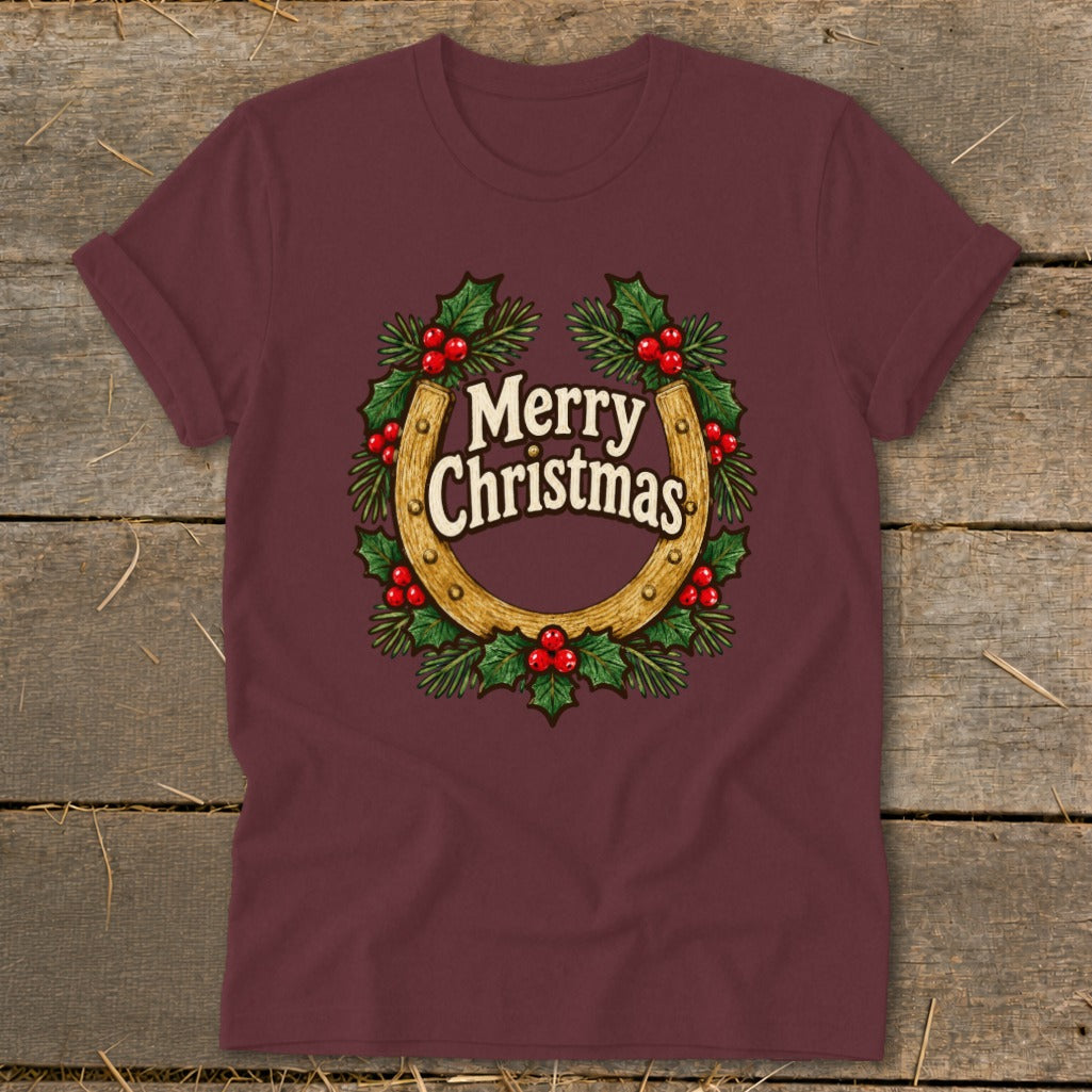 Maroon t-shirt with a horseshoe wreath graphic that says "Merry Christmas".