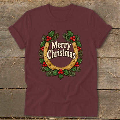 Maroon t-shirt with a horseshoe wreath graphic that says "Merry Christmas".