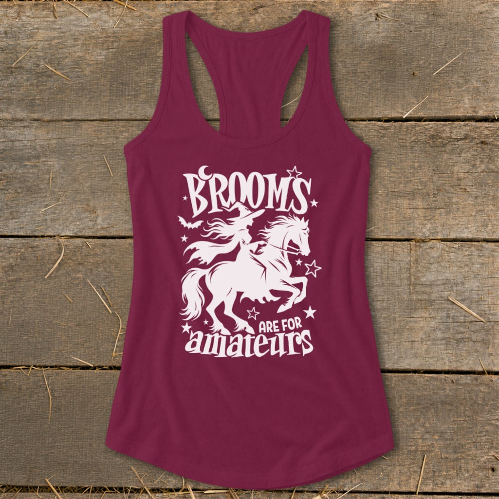 Maroon tank top with white graphic of witch riding horse, text "BROOMS ARE FOR amateurs".