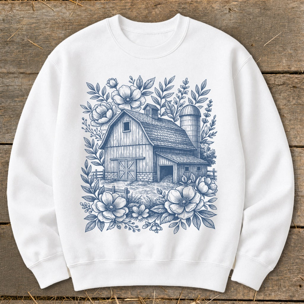 White sweatshirt with blue line drawing of a barn, silo, and flowers.