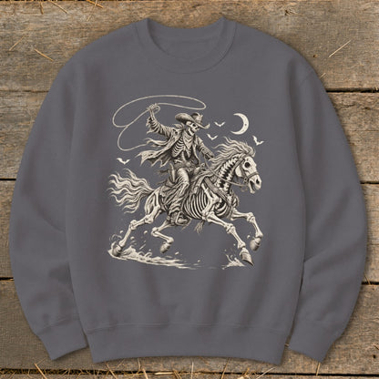 Skeleton cowboy on horseback with lasso, moon, and birds.