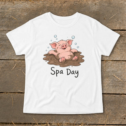 White t-shirt with illustration of a happy pig in mud, reading "Spa Day".