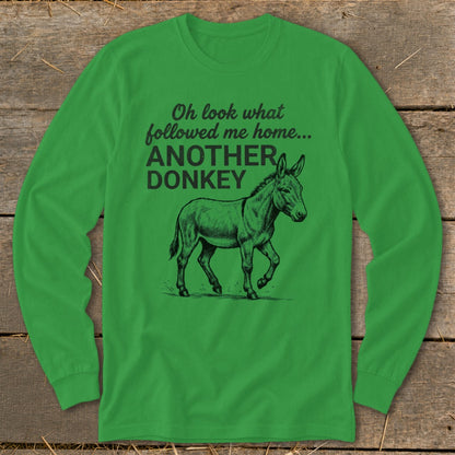Green long-sleeve shirt with text "Oh look what followed me home... ANOTHER DONKEY" and a donkey illustration.