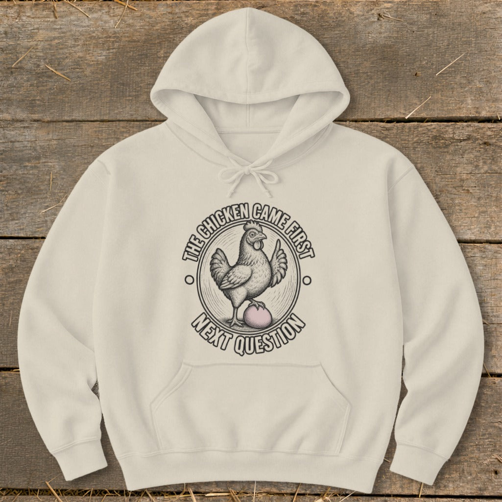 Cream hoodie with "The chicken came first next question" graphic.