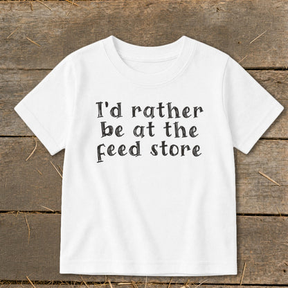 White t-shirt with black text that reads "I'd rather be at the feed store".