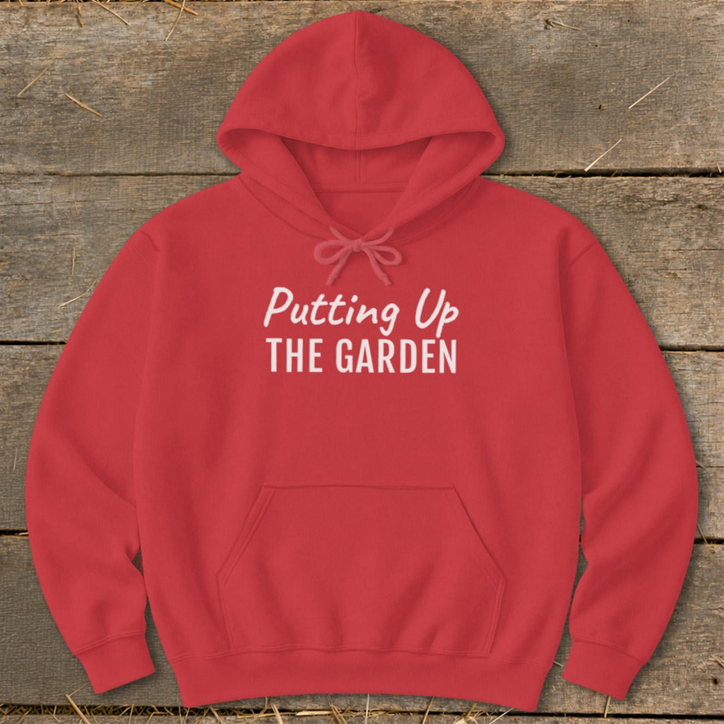 Red hoodie with "Putting Up THE GARDEN" printed in white text.