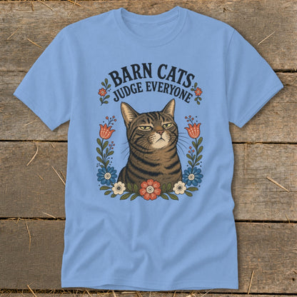 Light blue t-shirt with a tabby cat and the text "Barn Cats Judge Everyone".