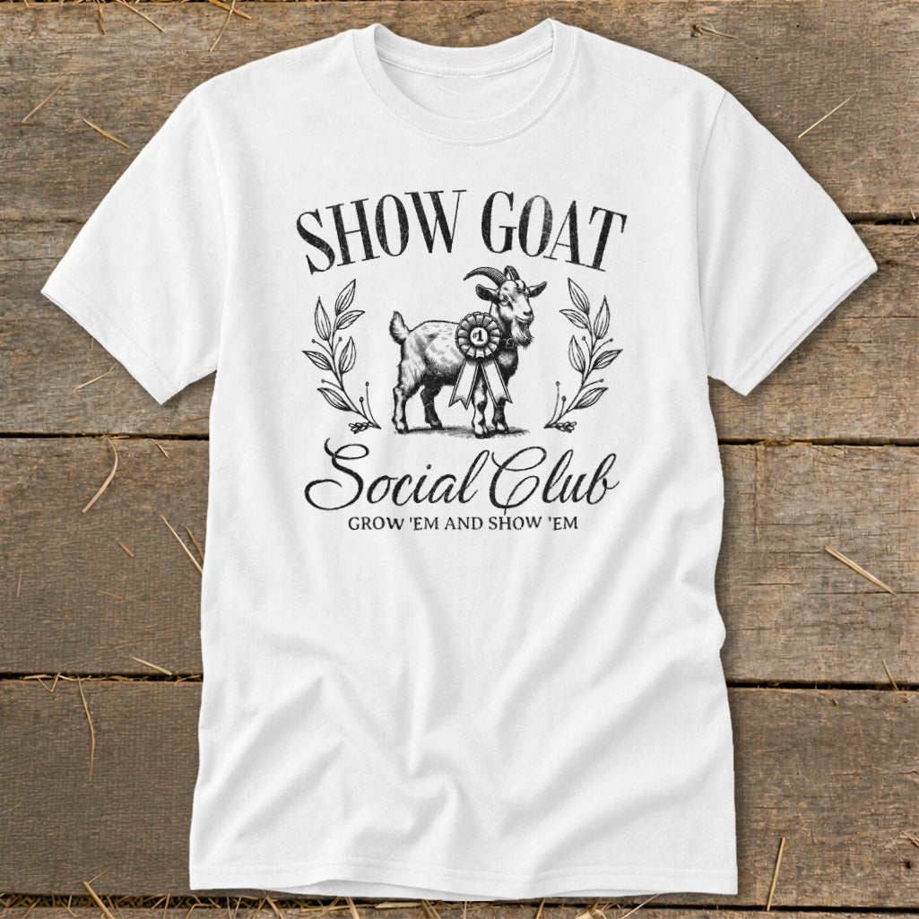 White t-shirt with black graphic of a goat wearing a blue ribbon and text "SHOW GOAT Social Club".