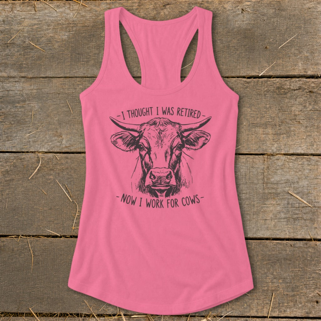 Pink tank top with cow illustration and text "I THOUGHT I WAS RETIRED - NOW I WORK FOR COWS".
