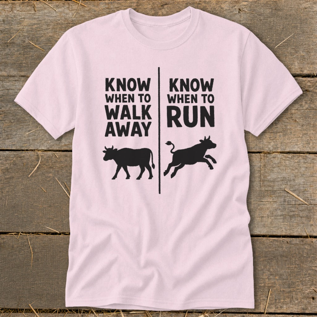 Pink t-shirt with text "Know When To Walk Away" and "Know When To Run" and cow graphics.