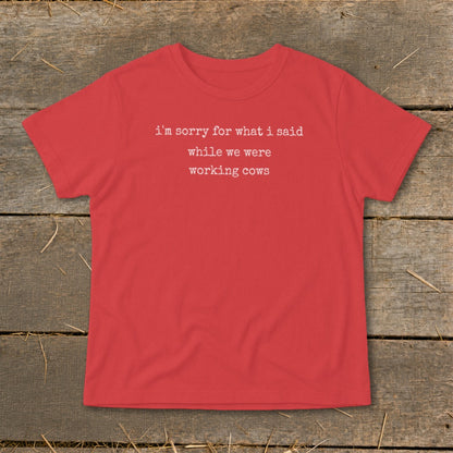 Red t-shirt with white text "i'm sorry for what i said while we were working cows".
