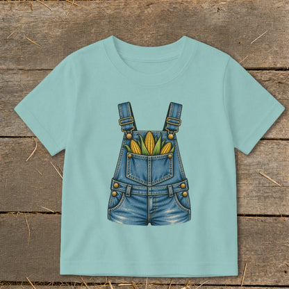 Light blue t-shirt with a denim overalls graphic holding corn on the cob.