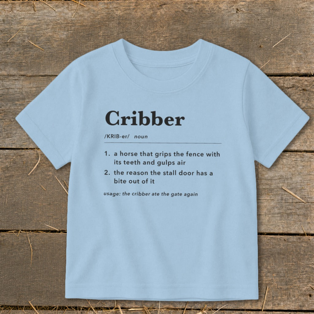 Light blue t-shirt featuring dictionary-style definitions for the word Cribber printed on the chest.