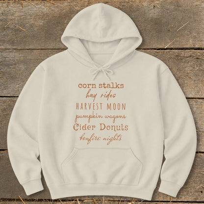 Cream hoodie with a list of fall phrases printed on the chest.