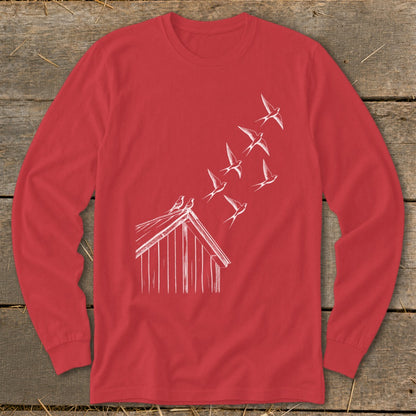 A red long-sleeve t-shirt with a white line drawing of birds flying from a barn roof.
