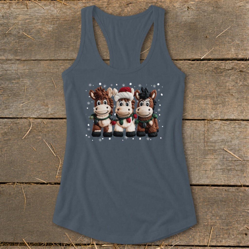 Three cartoon horses in Christmas attire and scarves stand in the snow.