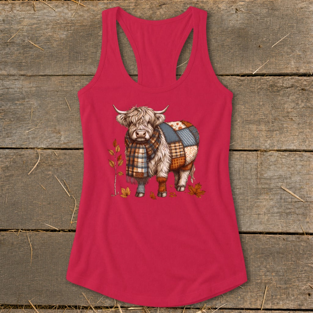 Highland cow wearing a plaid scarf and patchwork blanket on a pink tank top.
