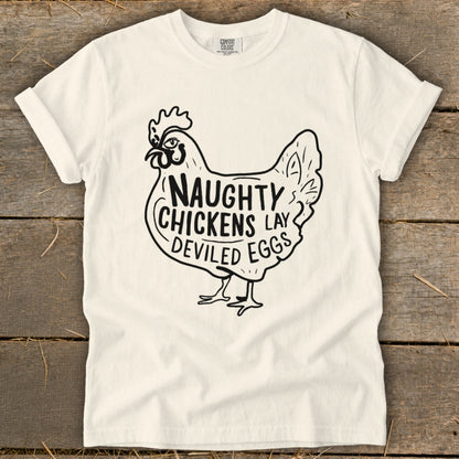 White t-shirt with black graphic of a chicken and text "Naughty Chickens Lay Deviled Eggs".