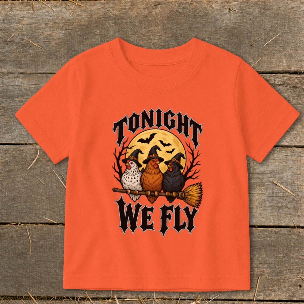 Orange t-shirt with three witch chickens on a broomstick and text "TONIGHT WE FLY".