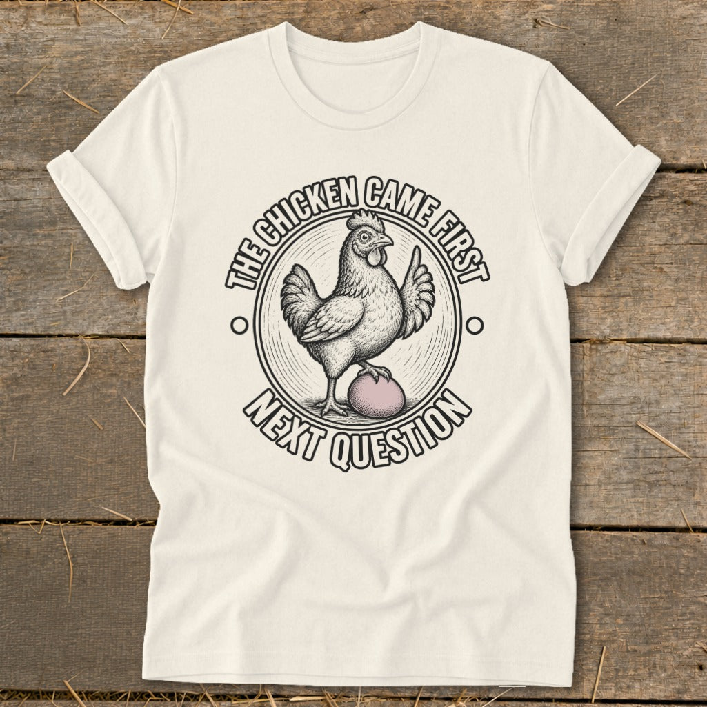 Cream t-shirt with chicken and egg graphic, text "The Chicken Came First Next Question".