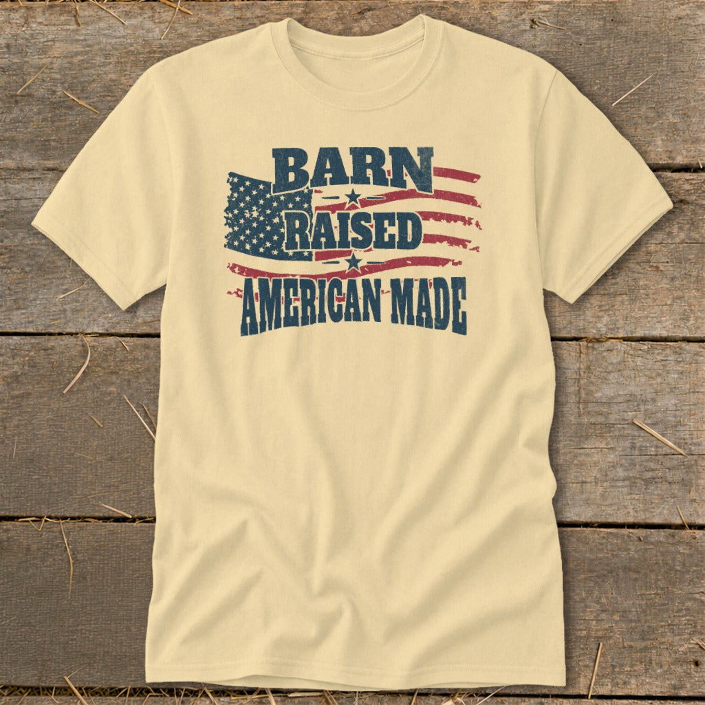 Cream t-shirt with distressed American flag graphic and text "BARN RAISED AMERICAN MADE."